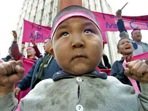 A close-up of a child that is participating in a protest.