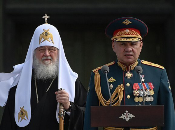 A photo of a military official and an Orthodox bishop.