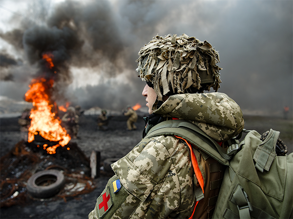 Image of Ukrainian soldier in front of fire. Image links to event page
