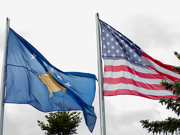 Image of Kosovar and American flag. Image links to event page.