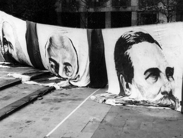 2023-11-04 Zilnik Conference Image of faces melting into sidewalks. Image links to event page.