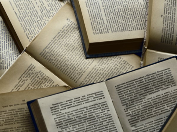 Multiple open books. Image links to event page.