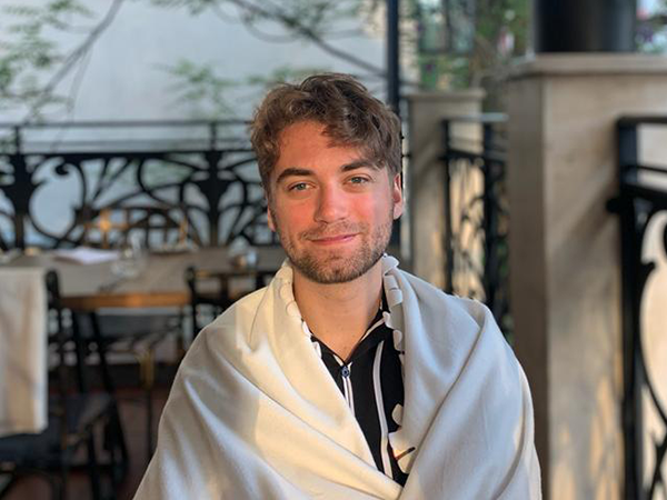 Photo of Bjorn Carlson enjoying a traditional Bulgarian meal in Sofia, Bulgaria. Summer 2022. Leads to a student spotlight interview.