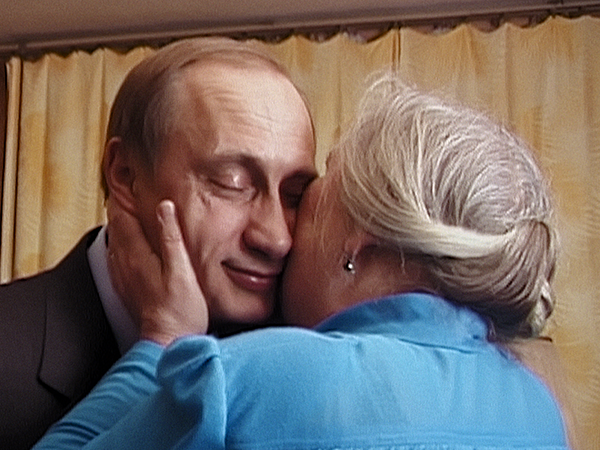 Putin being kissed on the cheek by a woman. Image links to event page.
