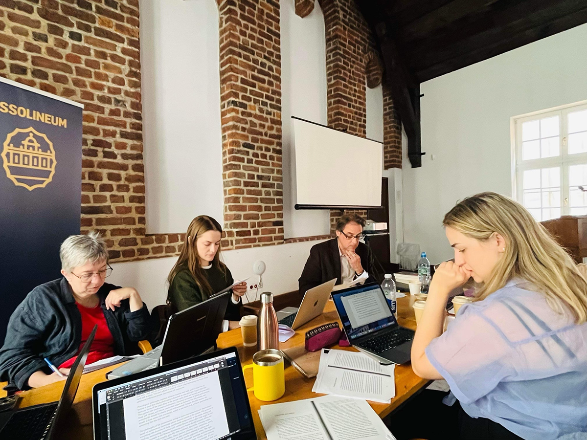 article p52 translating ukraine wkshp Workshop participants around a table.