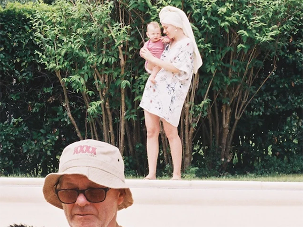 2025-03-15 Tata Woman holding a baby and a person at the front of the image. Image links to event page.