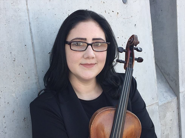 Alexandra Birch formatted for web Photo of Alexandra Birch with her violin. Leads to a postdoc spotlight interview
