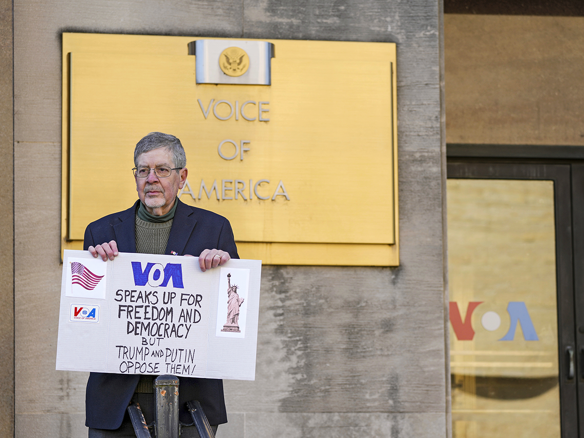 Steve Lodge, son of the late VoA Capitol Hill correspondent Robert Lodge, protesting in March 2025. Image links to event page.