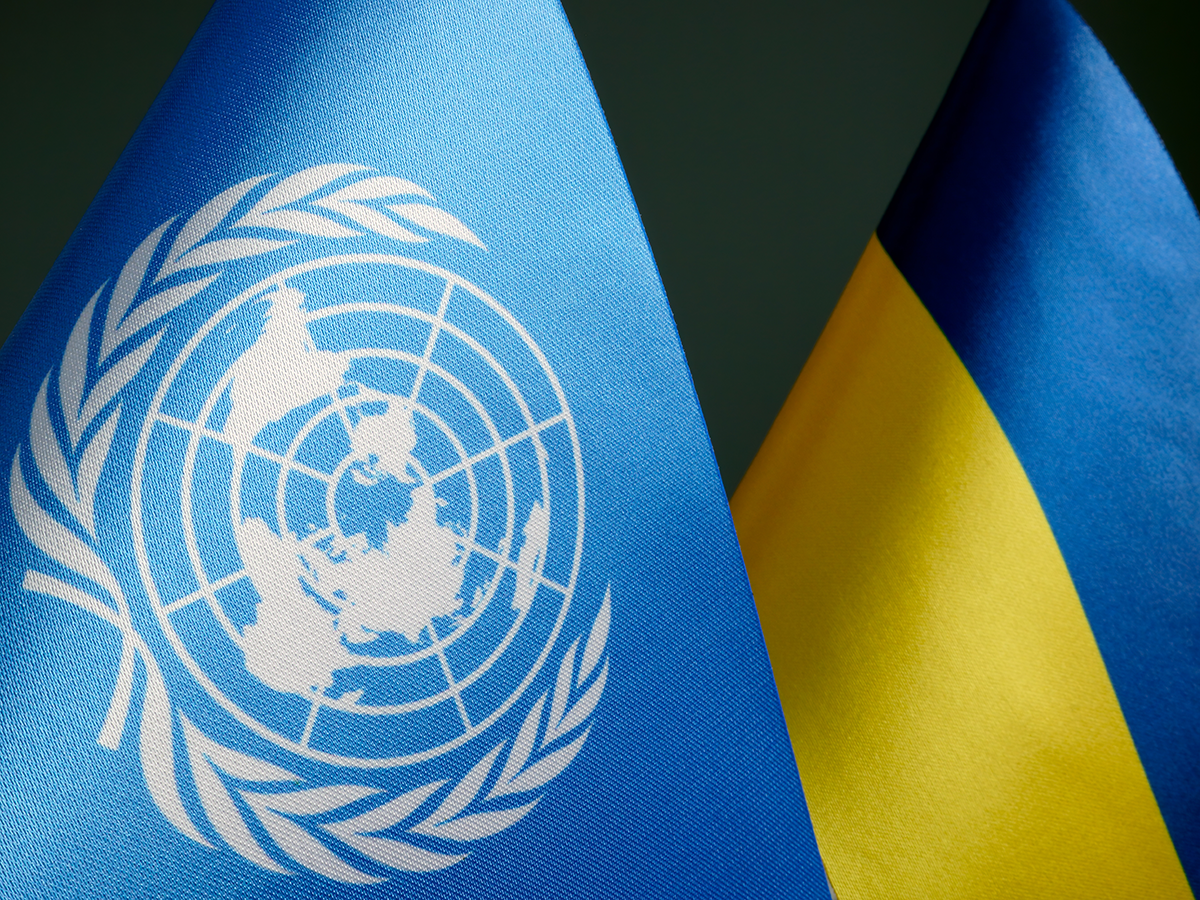 Ukraine and UN flags. Image links to event page.